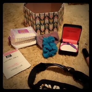 A headband,lipgloss,gourmet gun,wallet,scrunchies
